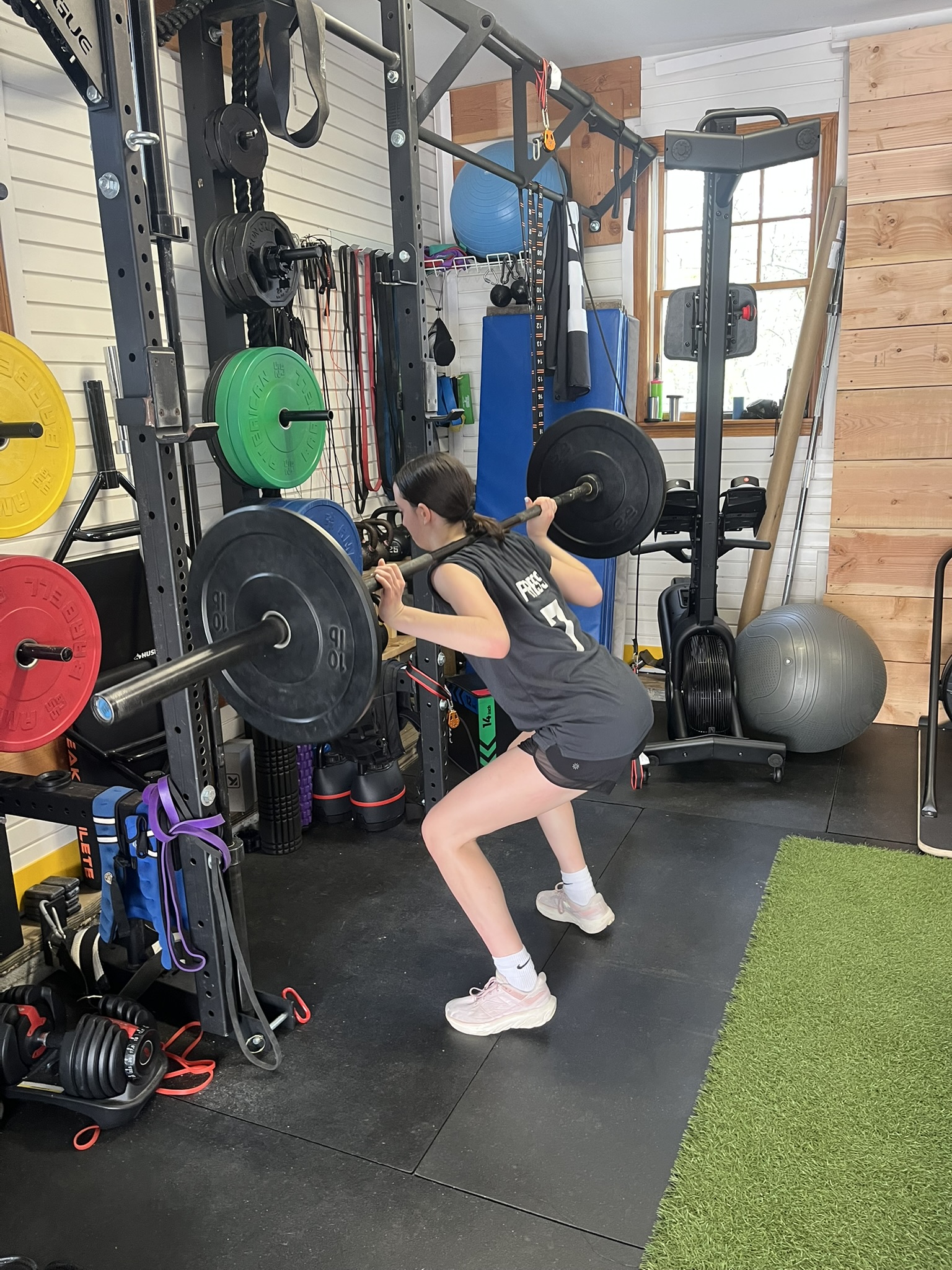 Athlete back-squatting in the gym
